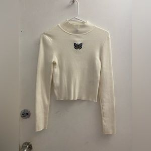 White butterfly turtleneck